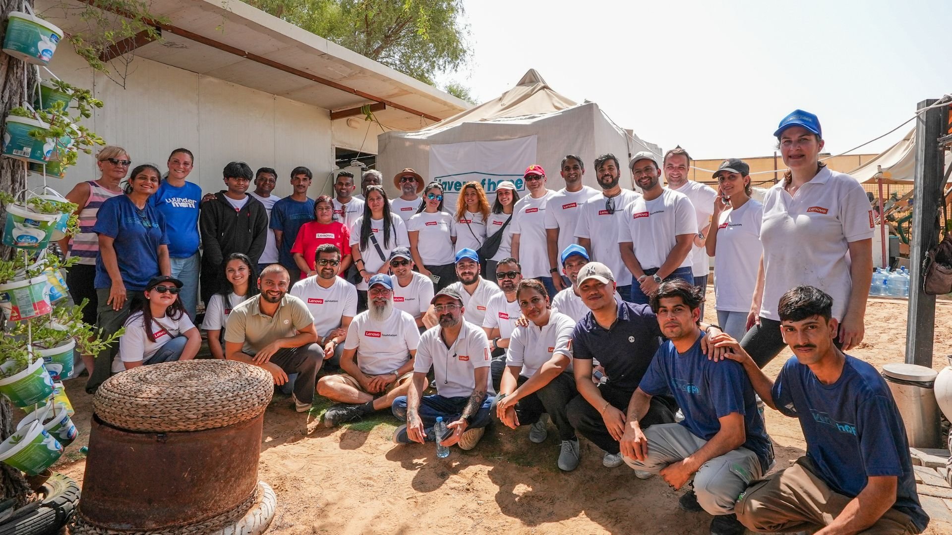 Alt text: Group photo of Lenovo volunteers with the Haven of Hope and Wunderdog teams at the sanctuary in Dubai